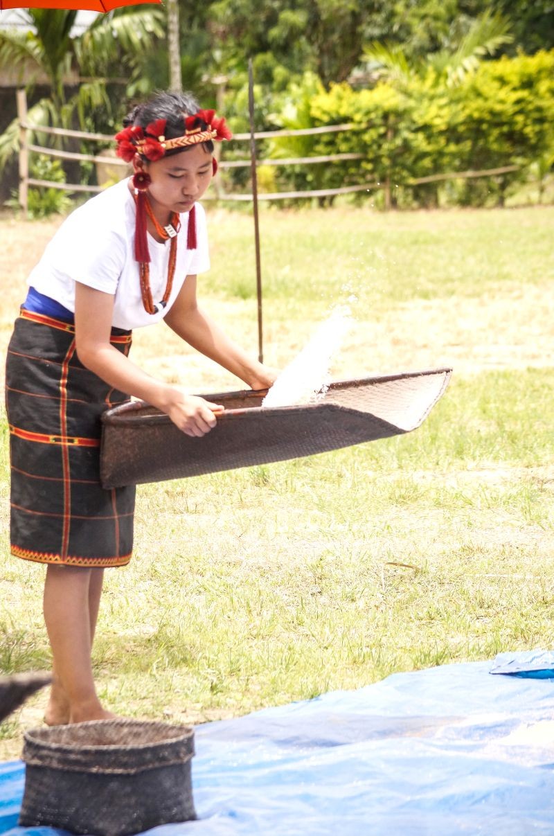 A young girl participates in rice winnowing competition during the Tuluni cultural festival organized Hovukhu village in Niuland on July 7 and 8. (Morung Photo)
