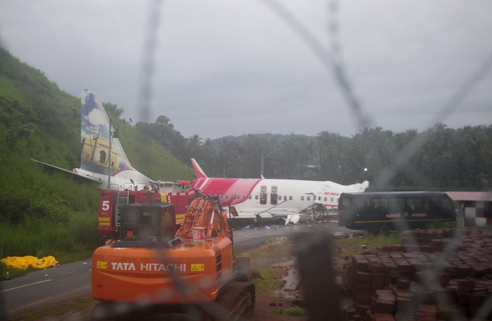 The Air India Express flight that skidded off a runway while landing at the airport in Kozhikode, Kerala state, India, Saturday, Aug. 8, 2020. The special evacuation flight bringing people home to India who had been trapped abroad because of the coronavirus skidded off the runway and split in two while landing in heavy rain killing more than a dozen people and injuring dozens more. (AP Photo/C.K.Thanseer)