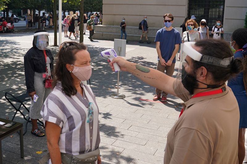 People have their temperature checked before attending The Metropolitan Museum of Art on their first day open since closing due to the coronavirus disease (COVID-19) outbreak.  Reuters. FILE PHOTO
