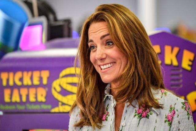 FILE PHOTO: Britain's Catherine, Duchess of Cambridge reacts at Island Leisure Amusement Arcade during her visit to Barry Island, South Wales, as local businesses reopen amid the coronavirus disease (COVID-19) outbreak, Britain August 5, 2020. Ben Birchall/Pool via REUTERS