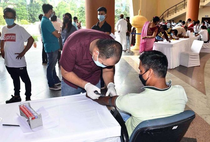 A man who has recovered from coronavirus donates plasma during a camp organised by the Bharatiya Janata Party at GMCH Auditorium in Guwahati. Photograph: ANI Photo