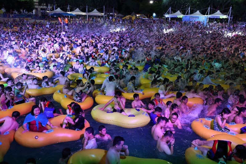 FILE PHOTO: People enjoy a music party inside a swimming pool at the Wuhan Maya Beach Park, in Wuhan, following the coronavirus disease (COVID-19) outbreak, Hubei province, China August 15, 2020. REUTERS/Stringer.