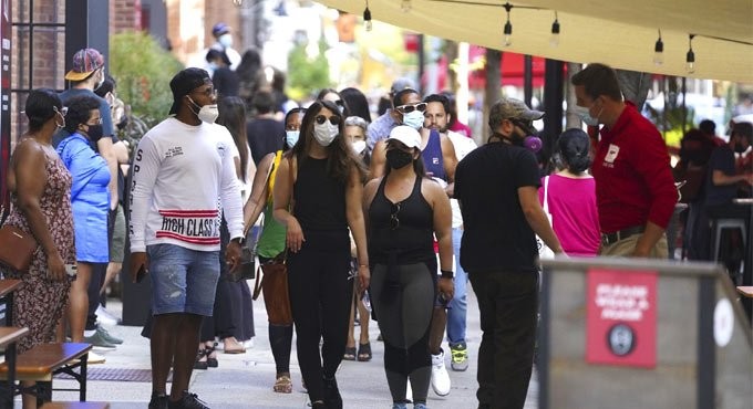 People are seen at the outdoor catering zone of the Chelsea Market in New York., Photo: IANS