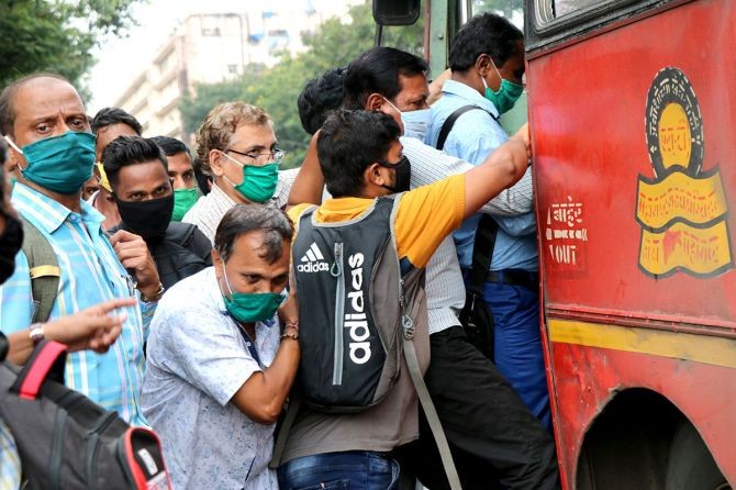 People board a passenger bus during rush hour at a bus terminal, amidst the coronavirus disease outbreak, in Mumbai. Photograph: /Niharika Kulkarni/Reuters