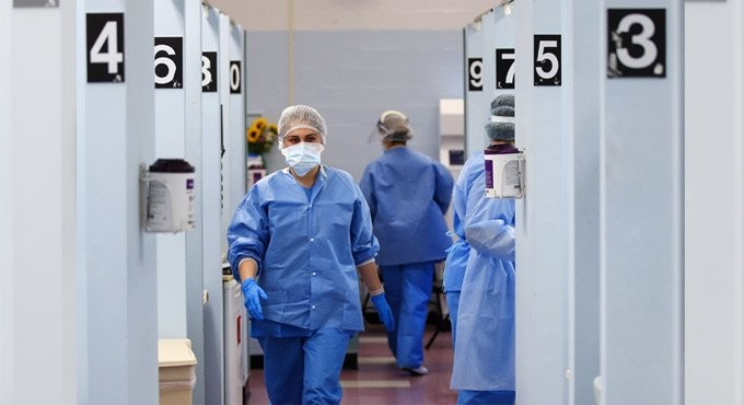 Medical personnel wearing personal protective equipment work in the COVID-19 medical screening annex at NYC Health + Hospitals Metropolitan. Photo: AP