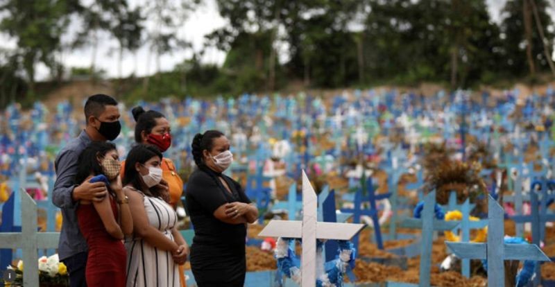 Relatives are seen during a mass burial of people who passed away due to the coronavirus disease (COVID-19), at the Parque Taruma cemetery in Manaus, Brazil, May 26, 2020. REUTERS/Bruno Kelly