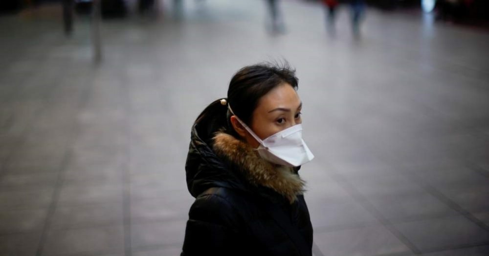 A woman wears a mask at a main shopping area as the country is hit by an outbreak of the new coronavirus in downtown Shanghai, China. (Reuters Photo)