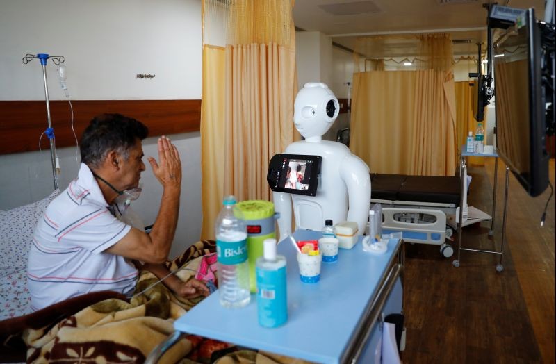 A patient suffering from the coronavirus disease (COVID-19) speaks to his family members, using a robot named 'Mitra' at the Intensive Care Unit (ICU) of the Yatharth Super Speciality Hospital in Noida, on the outskirts of New Delhi, India, September 15, 2020. Picture taken September 15, 2020. REUTERS/Adnan Abidi