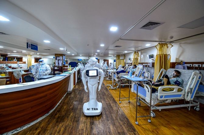 A robot operates inside a COVID-19 dedicated ward as patients undergo treatment, at in Greater Noida. The robot is capable of facilating communication between COVID-19 patients and their family member besides symptom and thermal checking. Photograph: Arun Sharma/PTI Photo