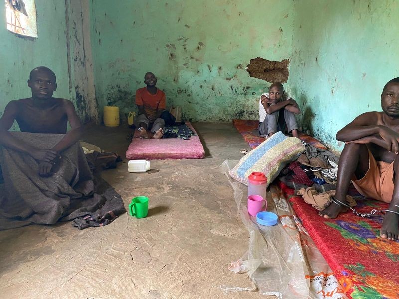 Men sit chained in a room at the Coptic Church Mamboleo, in Kisumu city, western Kenya, in this handout pictured obtained by Reuters on October 4, 2020. Kriti Sharma/Human Rights Watch/Handout via REUTERS