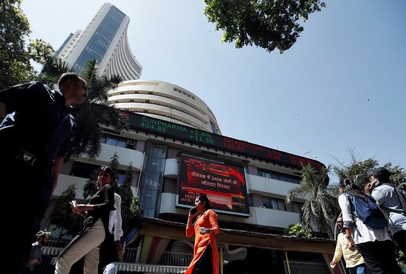 People walk past the Bombay Stock Exchange (BSE) building in Mumbai, India, March 9, 2020. REUTERS/Francis Mascarenhas/File photo