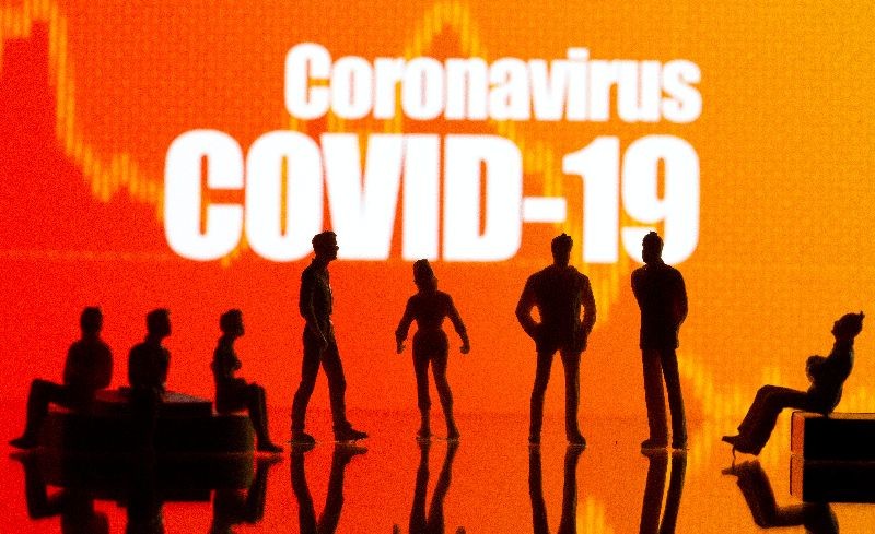 Small toy figures are seen in front of a Coronavirus Covid-19 and stock graph logo in this illustration taken, September 9, 2020. REUTERS/Dado Ruvic/Illustration