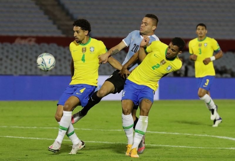 Brazil's Danilo and Marquinhos in action with Uruguay's Jonathan Rodriguez Raul Martinez/Pool via Reuters