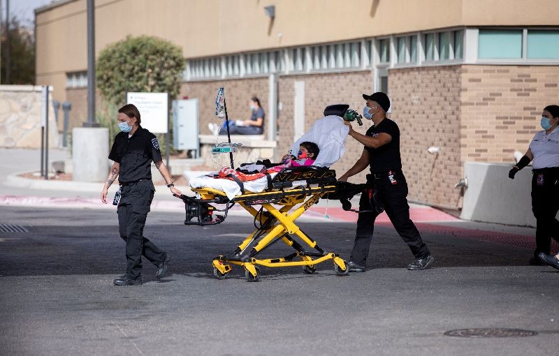 A boy is wheeled on a stretcher to an ambulance at the entrance of the emergency room at University Medical Center amid the coronavirus disease (COVID-19) outbreak, in El Paso, Texas, U.S. November 23, 2020. REUTERS/Ivan Pierre Aguirre