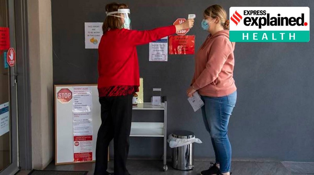 A patient has her temperature checked at a medical clinic in Melbourne (AP)