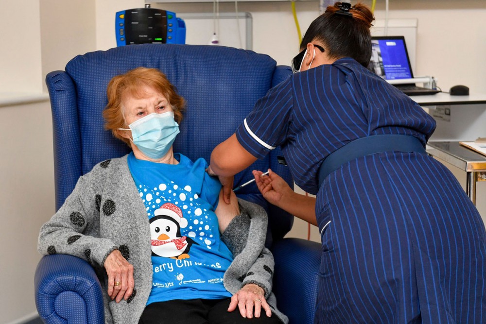 Margaret Keenan, the first patient in the UK to receive the Pfizer-BioNTech Covid-19 vaccine, receives a shot at University Hospital in Coventry, England on Dec. 8. Jacob King/Pool/AP
