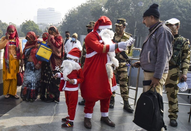 New Delhi: A volunteer dressed as Santa Claus distributes face masks during a COVID-19 awareness drive, in New Delhi, Wednesday, Dec 23, 2020. (PTI Photo)