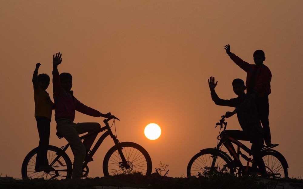 Patna: Young boys ride cycles during last sunset of the year 2020, in Patna, Thursday, Dec. 31, 2020, (PTI Photo)