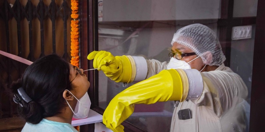 A medic collects samples for COVID-19 testing during total lockdown in Patna Wednesday July 15 2020. (Photo | PTI)