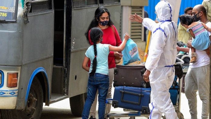 A health worker guides passengers to a quarantine centre on their arrival from the UK, at the Chennai International Airport (representational image) | PTI