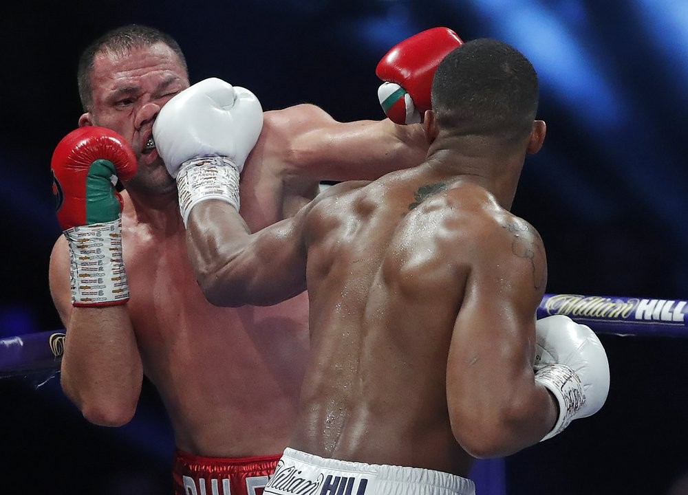 World Heavyweight boxing champion Britain's Anthony Joshua lands a blow on challenger Bulgaria's Kubrat Pulev during their Heavyweight title fight at Wembley Arena in London Saturday, Dec. 12, 2020. (Andrew Couldridge/Pool via AP)