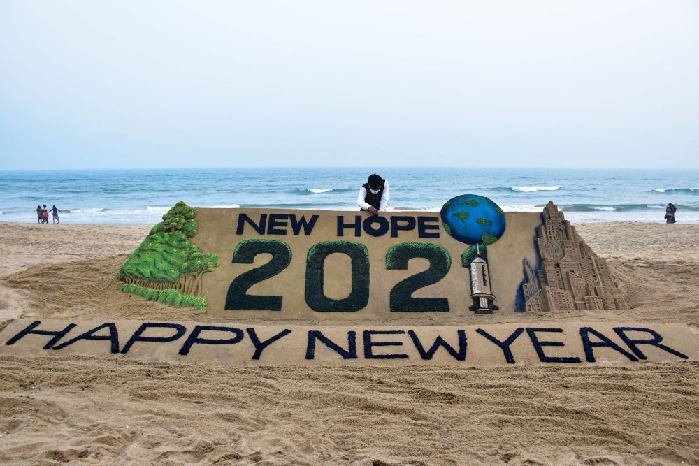 Puri: Sand artist Sudarshan Pattanaik creates a sand sculpture to welcome the year 2021, at Puri beach, Thursday, Dec. 31, 2020. (PTI Photo)
