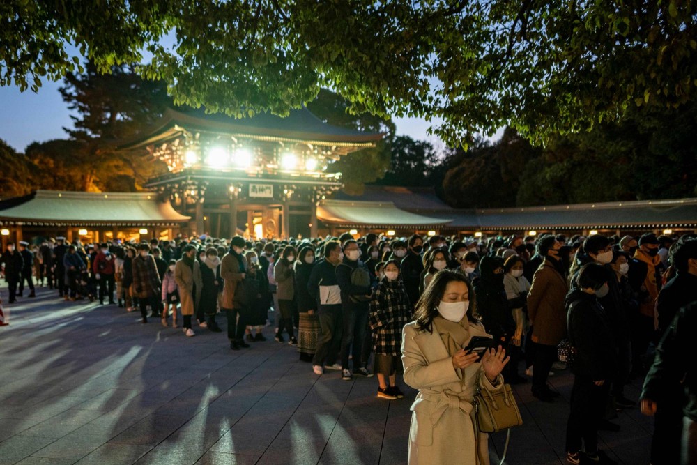 People offer prayers at Meiji Shrine in Tokyo on New Year's Day. Tokyo reported 841 new COVID-19 cases on Saturday amid an uptick in the number of infections. | AFP Photo