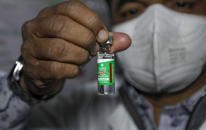 A health worker shows the Covishield vaccine in Ahmedabad. Photograph: PTI Photo