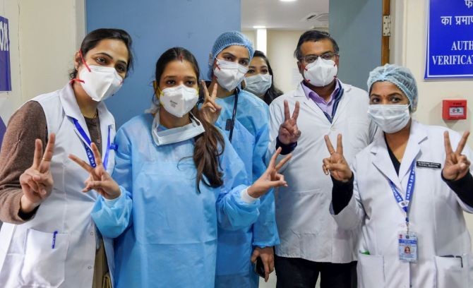 Doctors and health workers show victory signs as they pose for a photograph at RML Hospital, after the launch of the COVID-19 vaccination drive by Prime Minister Narendra Modi, in New Delhi, Saturday. Photograph: Atul Yadav/PTI Photo