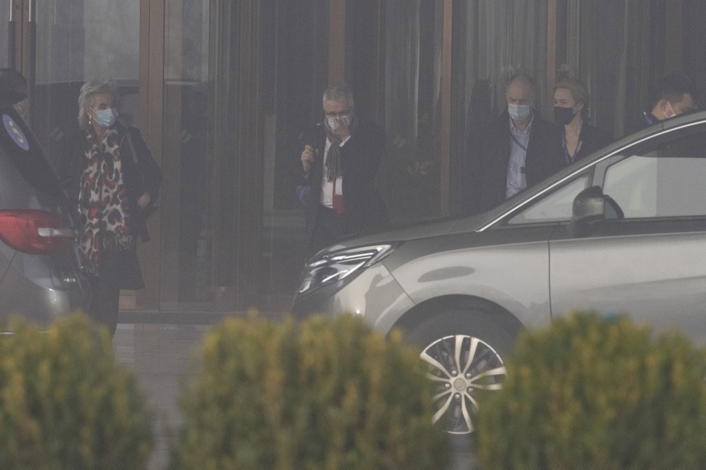 Members of a World Health Organization team leave their hotel on a foggy day for another day of field visit in Wuhan in central China's Hubei province on Wednesday, Feb. 3, 2021. The WHO team is investigating the origins of the coronavirus pandemic has visited two disease control centers in the province. (AP Photo/Ng Han Guan)
