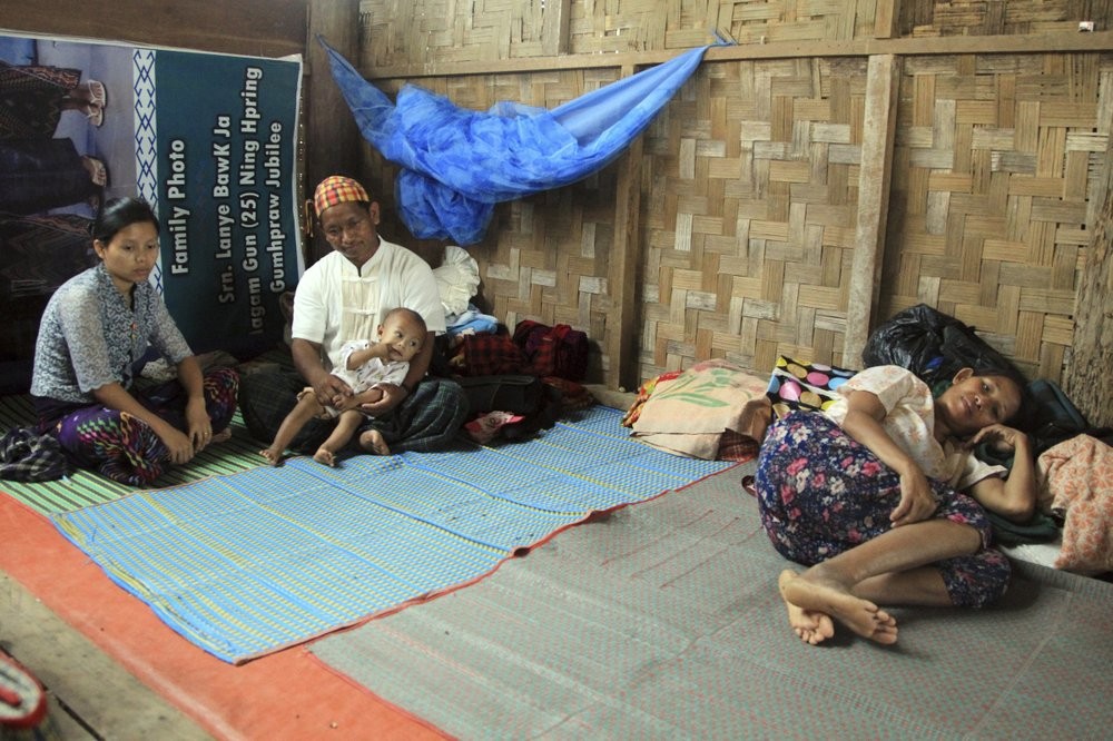FILE - In this May 6, 2018, file photo, internally displaced ethnic Kachins rest at their hut in compound of Trinity Baptist Church refugee camp in Myitkyina, Kachin State, northern Myanmar. Far away in Myanmar’s borderlands, millions of others who hail from Myanmar’s minority ethnic groups are facing increasing uncertainty and waning security as longstanding conflicts between the military and minority guerrilla armies flare anew. (AP Photo)