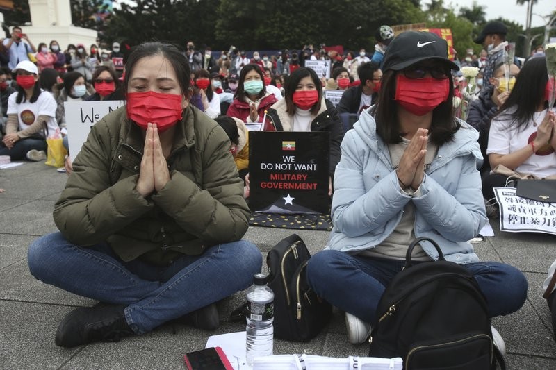 Myanmar nationals living in Taiwan pray for victims and express their disdain against the military regime in Myanmar during a demonstration at Liberty Square in Taipei, Taiwan, Sunday, March 21, 2021. (AP Photo/Chiang Ying-ying)