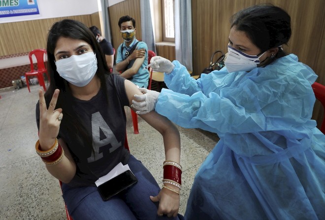 A woman receives a Covid vaccine dose in Jammu on Tuesday. PTI