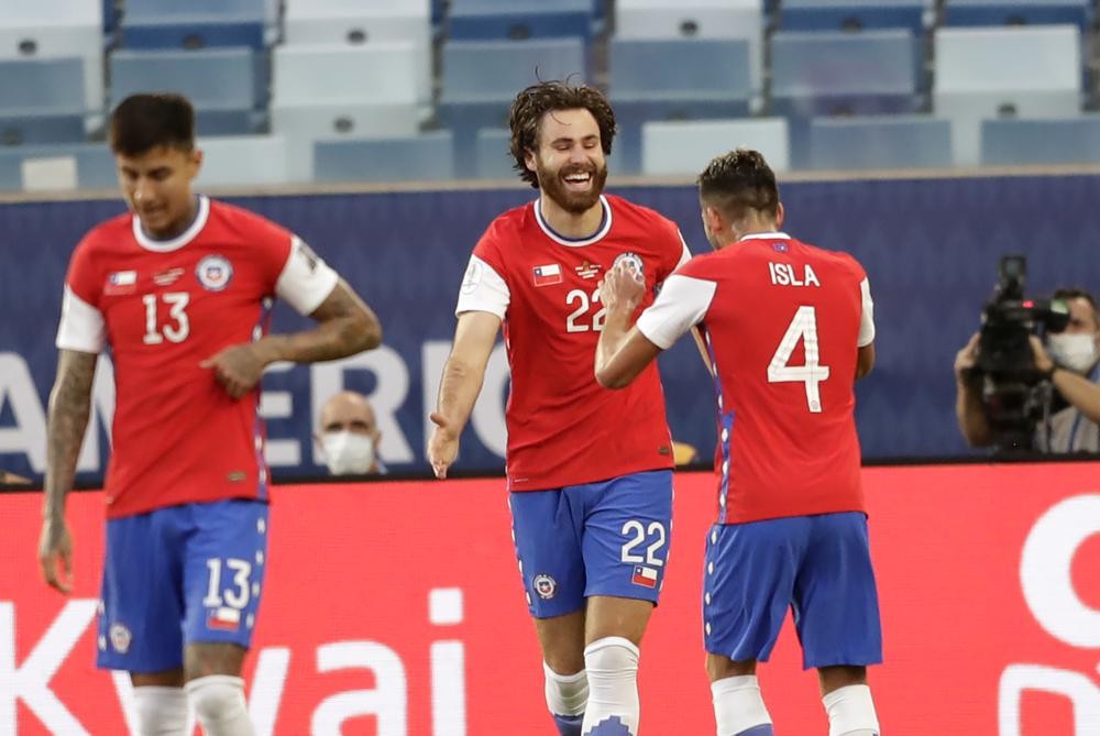Chile's Ben Brereton, center, celebrates scoring his side's opening goal against Bolivia during a Copa America soccer match at Arena Pantanal stadium in Cuiaba, Brazil, Friday, June 18, 2021. (AP Photo/Andre Penner)