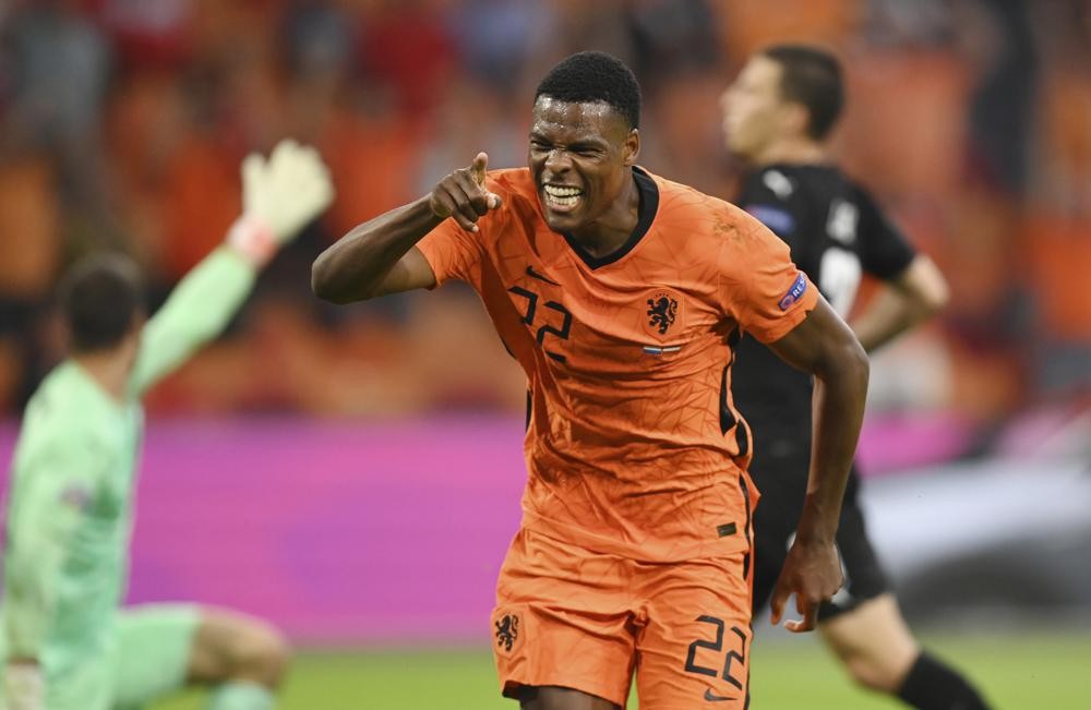 Denzel Dumfries of the Netherlands celebrates after scoring his side's second goal during the Euro 2020 soccer championship group C match between the The Netherlands and Austria at Johan Cruijff ArenA in Amsterdam, Netherlands, Thursday, June 17, 2021. (John Thys, Pool via AP)