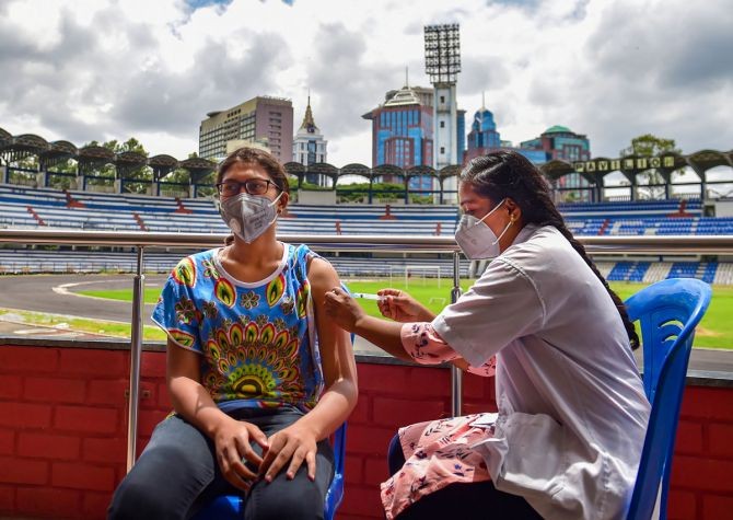 A health worker administers a dose of COVID-19 vaccine to a sportsperson, at Kanteerava Stadium in Bengaluru. Photograph: Shailendra Bhojak/PTI Photo
