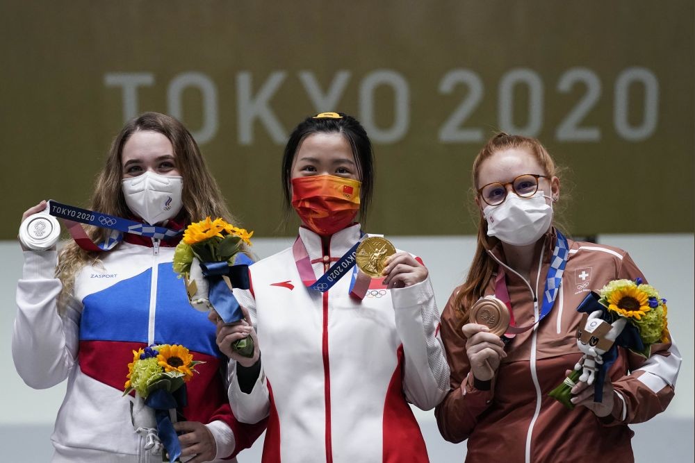 Tokyo:  Silver medalist Anastasiia Galashina, left, of the Russian Olympic Committee, gold medalist Yang Qian, of China, center, and bronze medalist Nina Christen, of Switzerland stand after the women's 10-meter air rifle at the Asaka Shooting Range in the 2020 Summer Olympics, Saturday, July 24, 2021, in Tokyo, Japan.AP/PTI(