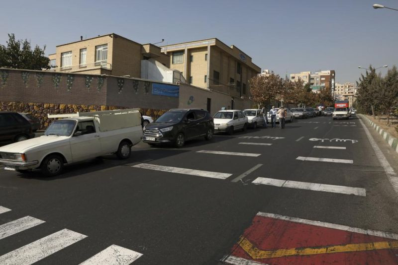 Cars wait in line to fill up at a gas station because pumps machines are out of service, in Tehran, Iran on October 26, 2021. Gas stations across Iran on Tuesday suffered a widespread outage of a system that allows consumers to buy fuel with a government-issued card, stopping sales. One semiofficial news agency referred to the incident as a cyberattack. (AP Photo)