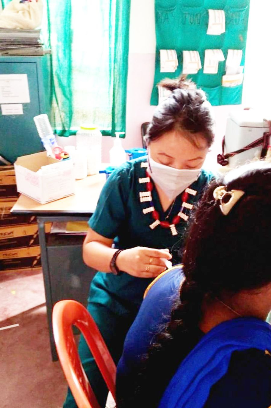 A health care worker administers a COVID-19 vaccine dose in Nagaland.