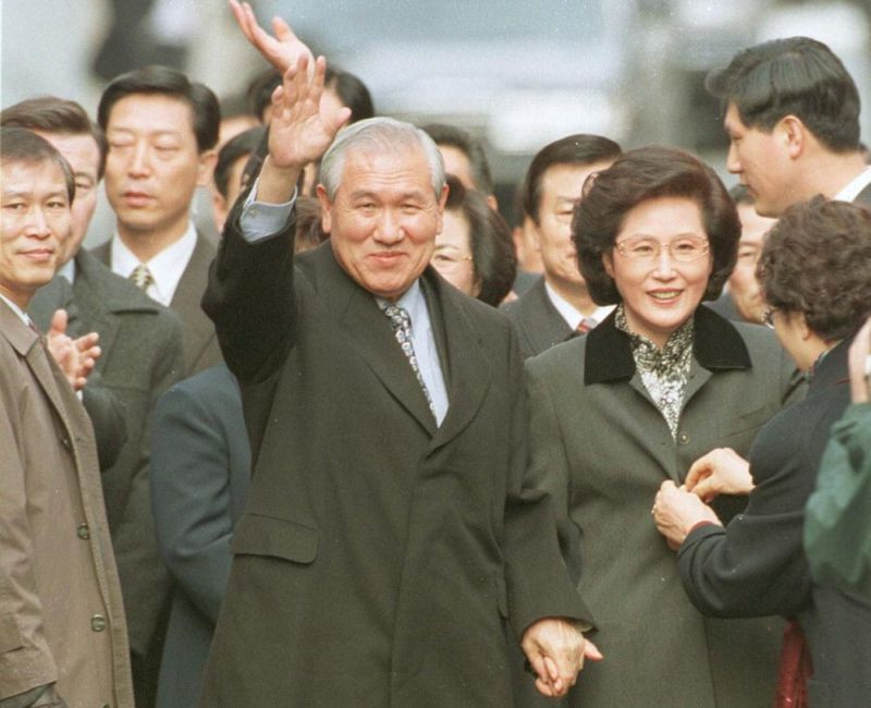 In this Dec. 22, 1997, file photo former South Korean President Roh Tae-woo, with his wife Kim Ok-sook standing beside him, waves to his supporters and neighbors upon arrival at his home after he was released from the Seoul prison in a special amnesty. Seoul hospital says Tuesday, Oct. 26, 2021, former South Korean President Roh has died (AP File Photo)