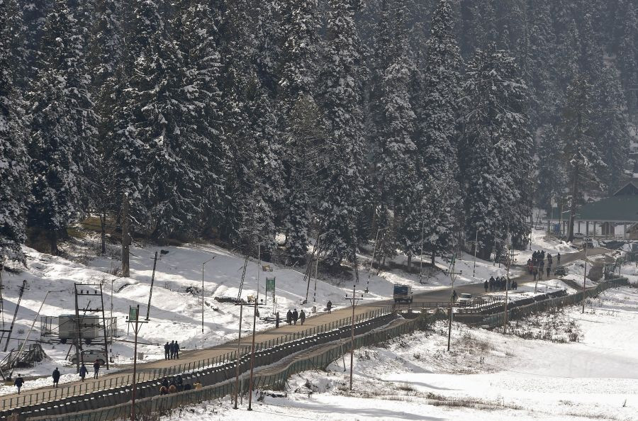 Gulmarg: People walk on a road after a light snowfall at ski resort Gulmarg in Baramulla District of North Kashmir, Saturday, Nov. 6, 2021. (PTI Photo/S. Irfan)