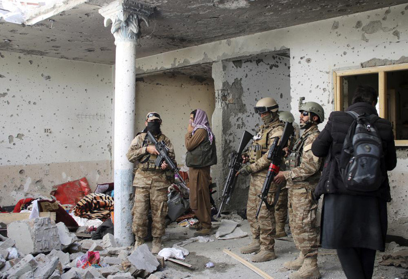 Taliban fighters inspect a house after an 8-hour gunbattle erupted between Taliban and Islamic State group fighters, when Taliban forces raided a suspected hideout of IS militants on the outskirts of Jalalabad, east of Kabul, Afghanistan, Tuesday, Nov. 30, 2021. Taliban fighters have summarily killed or forcibly “disappeared” more than 100 former police and intelligence officers since taking power in Afghanistan, Human Rights Watch said in a report Tuesday. (AP Photo)