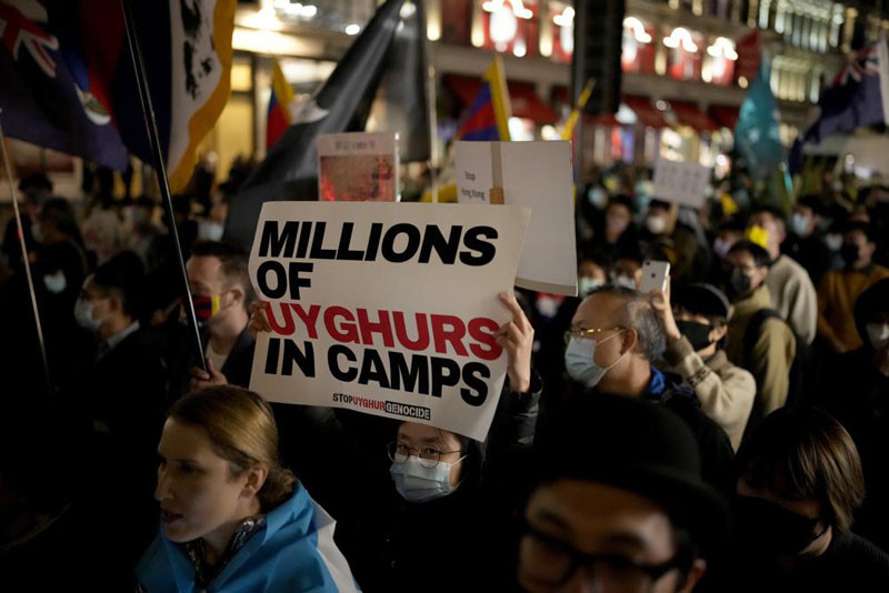 Demonstrators supporting Tibetans, Uyghurs and Hong Kongers take part in a protest against the Chinese Communist Party (CCP) to coincide with the 72nd National Day of the People's Republic of China, as they march along Regent Street towards the Chinese Embassy, in London, on Oct. 1, 2021. The U.S. Holocaust Memorial Museum says it has compiled evidence of increasing government repression against Uyghur Muslims in China's western Xinjiang region (AP File Photo)