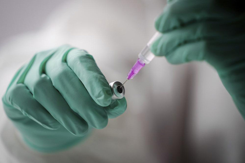 An employee draws up a syringe with the Pfizer vaccine against the coronavirus and the COVID-19 disease at vaccination bus in Berlin, Germany, Tuesday, Nov. 23, 2021. Germany battles rising numbers of coronavirus infections. (AP Photo)