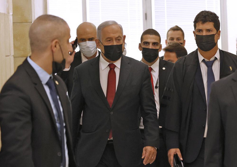 Former Israeli prime minister Benjamin Netanyahu, center, arrives for a court hearing on corruption charges Tuesday, Nov. 16, 2021, in Jerusalem. Netanyahu appeared in court for the first time in over half a year on Tuesday as a one-time confidant prepared to take the stand against him in a high-profile corruption case against the former Israeli prime minister. (AP Photo)