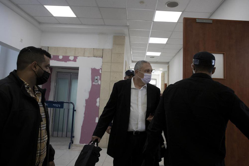 Nir Hefetz, center, a former aide to Benjamin Netanyahu, arrives to testify as a star witness in the former Israeli prime minister's corruption trial at the District Court in east Jerusalem, Monday, Nov. 22, 2021. (AP Photo)