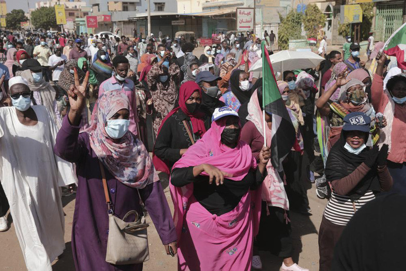 People protest in Khartoum, Sudan on November 13, 2021. Pro-democracy protesters took to the streets across Sudan to rally against the military's takeover last month. The rallies, called by the pro-democracy movement, came two days after the top general behind the coup reappointed himself head of the Sovereign Council, Sudan's interim governing body. (AP Photo)
