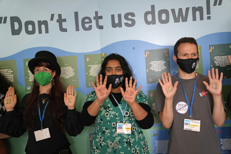 Climate activists stage a small demonstration at at the COP26 U.N. Climate Summit in Glasgow, Scotland on November 9, 2021. The U.N. climate summit in Glasgow has entered it's second week as leaders from around the world, are gathering in Scotland's biggest city, to lay out their vision for addressing the common challenge of global warming. (AP Photo)