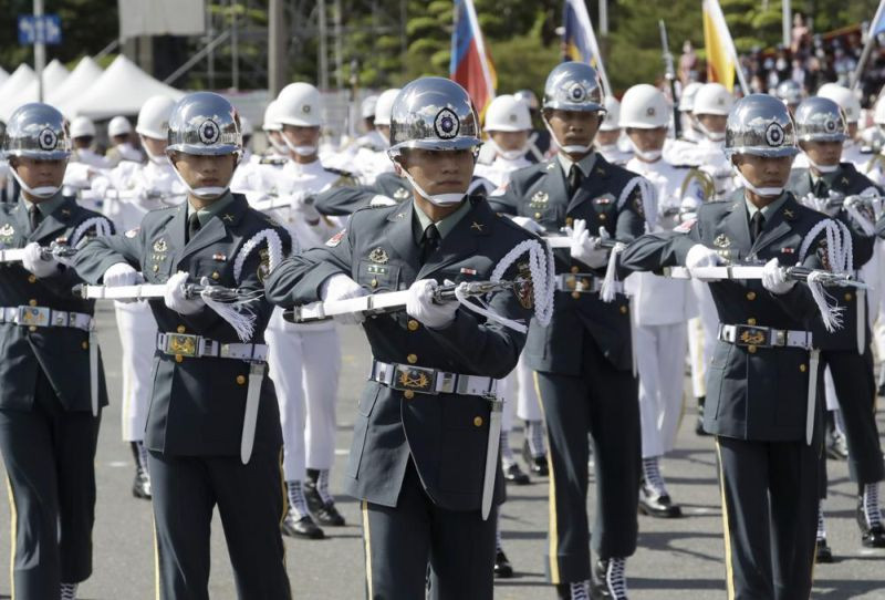 The Taiwan military honor guard performs during National Day celebrations in front of the Presidential Building in Taipei, Taiwan, Sunday, Oct. 10, 2021. Taiwan's Defense Ministry on Tuesday, Nov. 9, 2021, said China is seeking to take control of the island by wearing down its military capabilities and influencing public opinion, while avoiding an all-out military conflict that could likely draw in the United States. (AP File Photo)