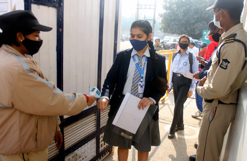 A student undergoes thermal screening before entering an examination centre to appear in the CBSE 12th Board Exams 2022 for Term 1, in Gurugram on November 29, 2021. (PTI Photo)